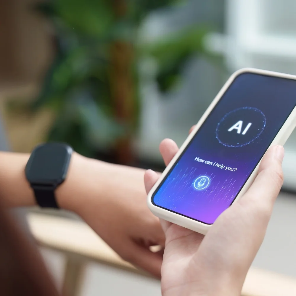 Hand holds a phone showing an AI assistant chat screen for Trumbull
