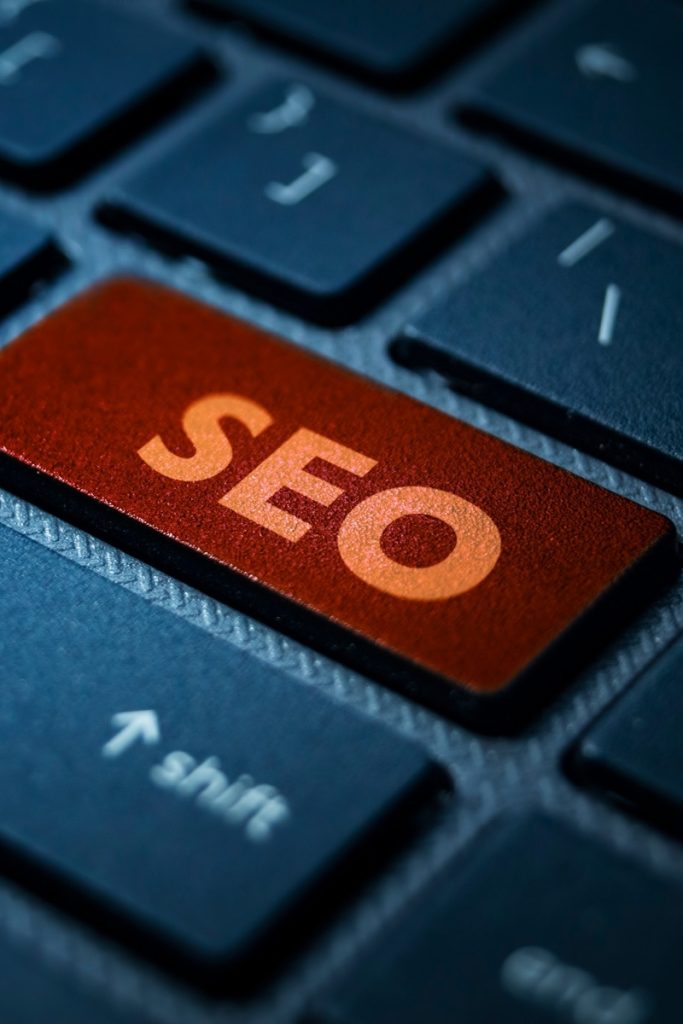 SEO printed on an orange key among others